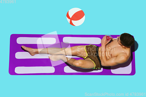 Image of Top view of young caucasian male model\'s resting on beach resort