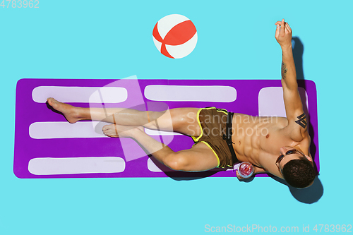 Image of Top view of young caucasian male model\'s resting on beach resort