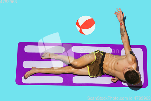 Image of Top view of young caucasian male model\'s resting on beach resort