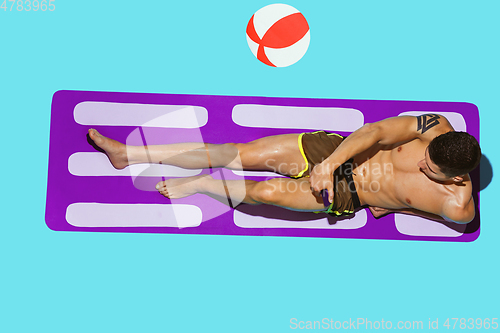 Image of Top view of young caucasian male model\'s resting on beach resort