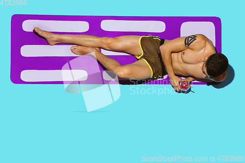 Image of Top view of young caucasian male model\'s resting on beach resort