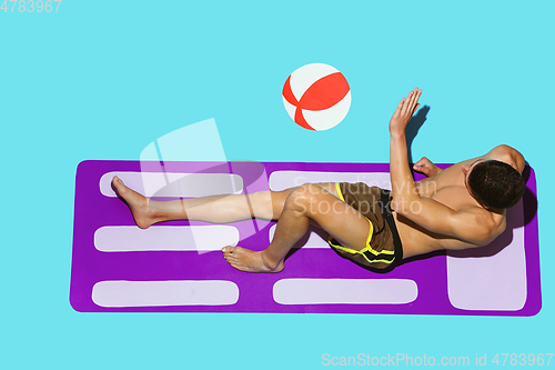 Image of Top view of young caucasian male model\'s resting on beach resort