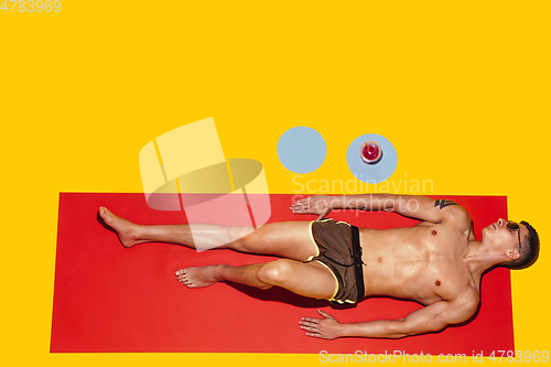 Image of Top view of young caucasian male model\'s resting on beach resort