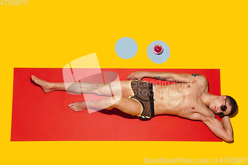 Image of Top view of young caucasian male model\'s resting on beach resort