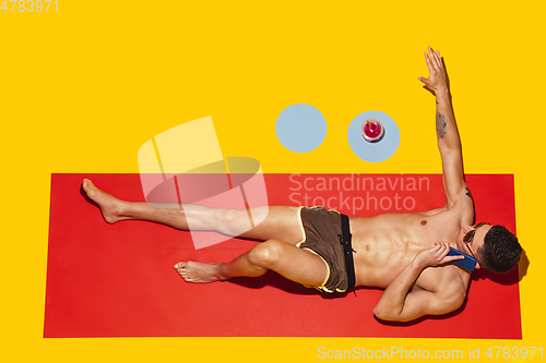 Image of Top view of young caucasian male model\'s resting on beach resort