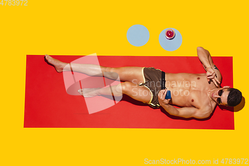 Image of Top view of young caucasian male model\'s resting on beach resort