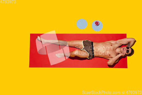 Image of Top view of young caucasian male model\'s resting on beach resort