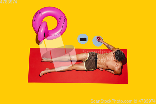 Image of Top view of young caucasian male model\'s resting on beach resort