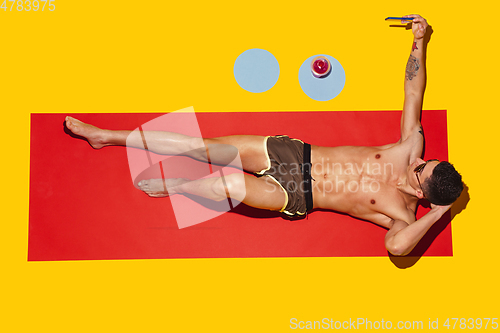 Image of Top view of young caucasian male model\'s resting on beach resort