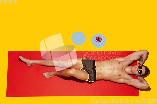 Image of Top view of young caucasian male model\'s resting on beach resort