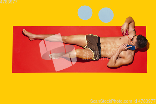 Image of Top view of young caucasian male model\'s resting on beach resort