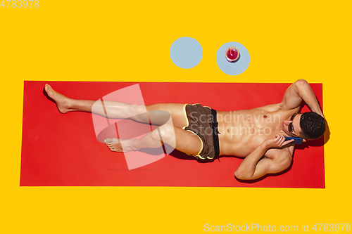 Image of Top view of young caucasian male model\'s resting on beach resort