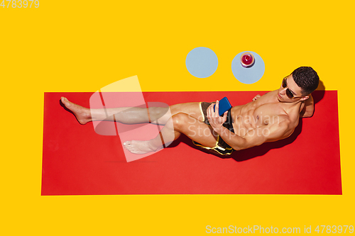 Image of Top view of young caucasian male model\'s resting on beach resort