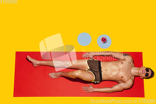 Image of Top view of young caucasian male model\'s resting on beach resort
