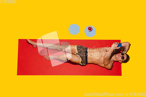 Image of Top view of young caucasian male model\'s resting on beach resort