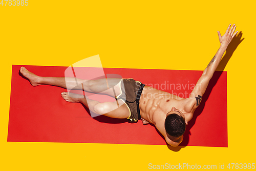 Image of Top view of young caucasian male model\'s resting on beach resort
