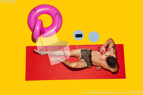 Image of Top view of young caucasian male model\'s resting on beach resort