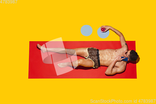 Image of Top view of young caucasian male model\'s resting on beach resort