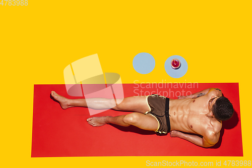 Image of Top view of young caucasian male model\'s resting on beach resort