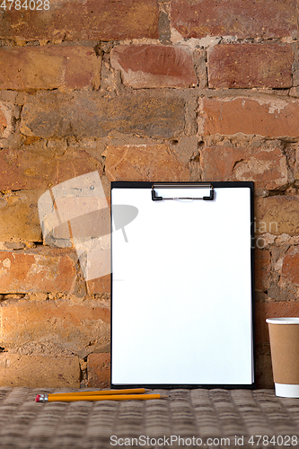 Image of Mock up blank picture or sheet on the brick wall background