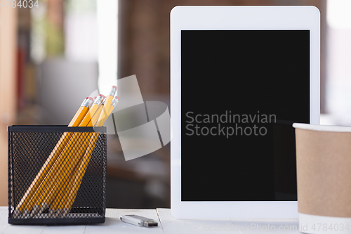 Image of Mock up empty black tablet screen on blured background