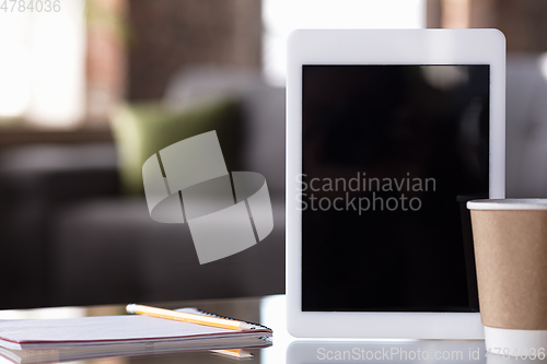 Image of Mock up empty black tablet screen on blured background