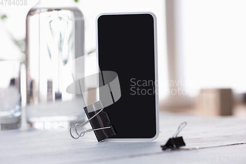 Image of Mock up empty black smartphone screen on blured background