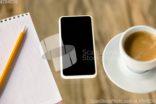 Image of Mock up empty black smartphone screen on wooden table background