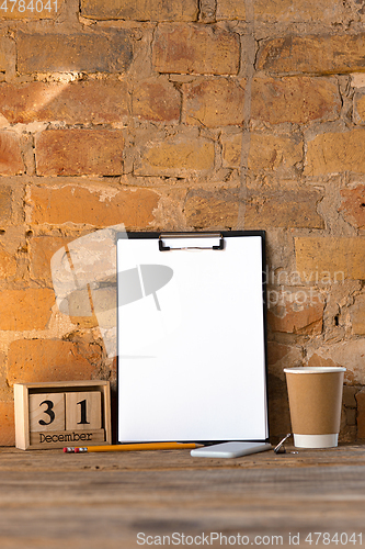 Image of Mock up blank picture or sheet on the brick wall background