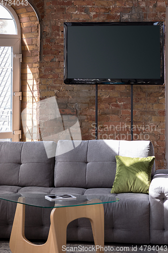 Image of Mock up blank television screen on the brick wall background