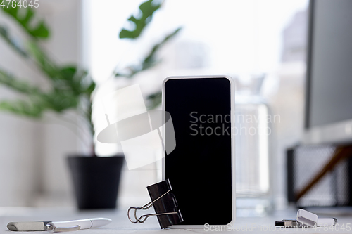 Image of Mock up empty black smartphone screen on blured background