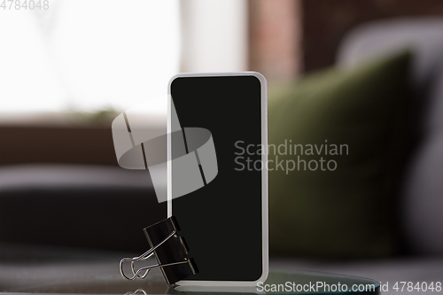 Image of Mock up empty black smartphone screen on blured background