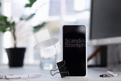 Image of Mock up empty black smartphone screen on blured background
