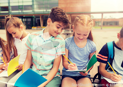 Image of group of happy elementary school students outdoors