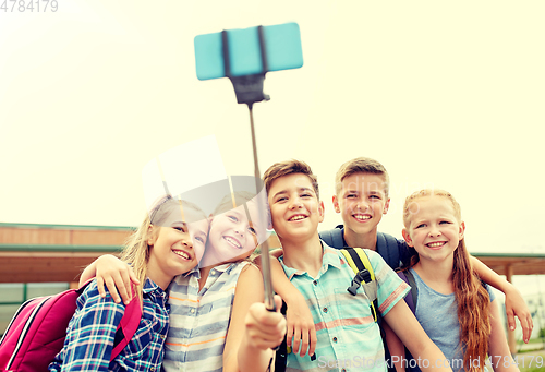 Image of happy elementary school students taking selfie