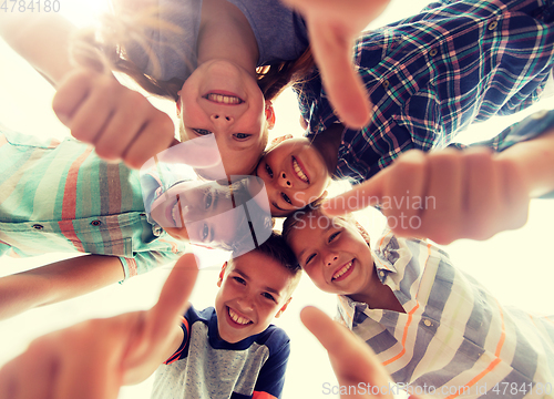 Image of happy children showing thumbs up in circle