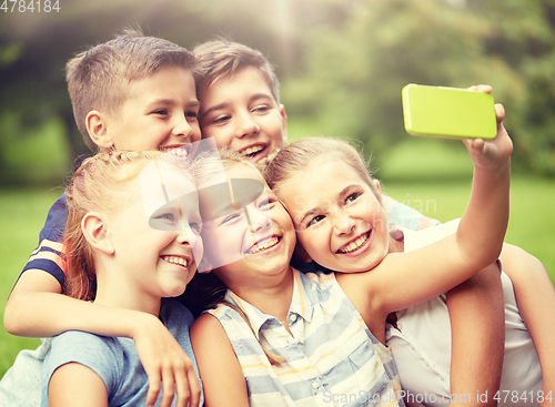 Image of happy kids or friends taking selfie in summer park