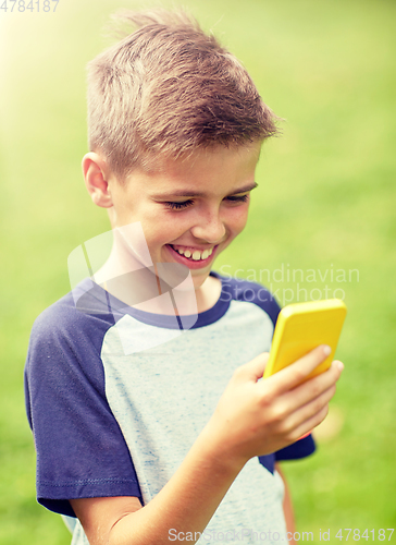 Image of boy with smartphone playing game in summer park