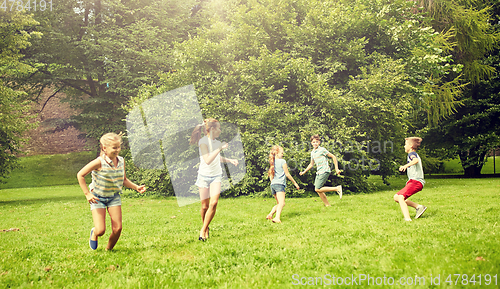 Image of happy kids running and playing game outdoors