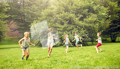 Image of happy kids running and playing game outdoors