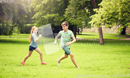 Image of happy kids running and playing game outdoors