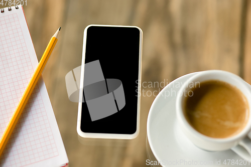 Image of Mock up empty black smartphone screen on wooden table background