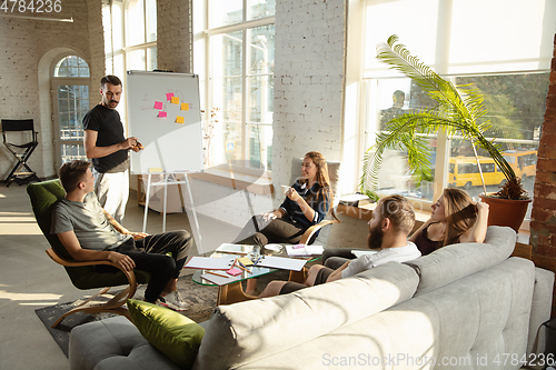 Image of Group of young caucasian office workers have creative meeting to discuss new ideas