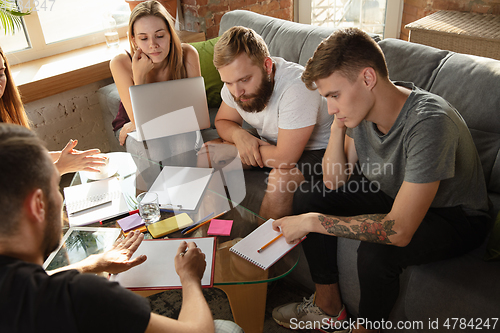 Image of Group of young caucasian office workers have creative meeting to discuss new ideas