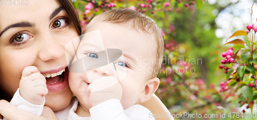 Image of mother with baby over spring garden background