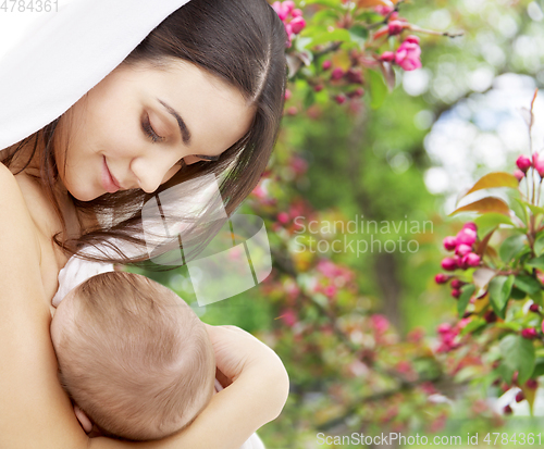 Image of mother with baby over spring garden background