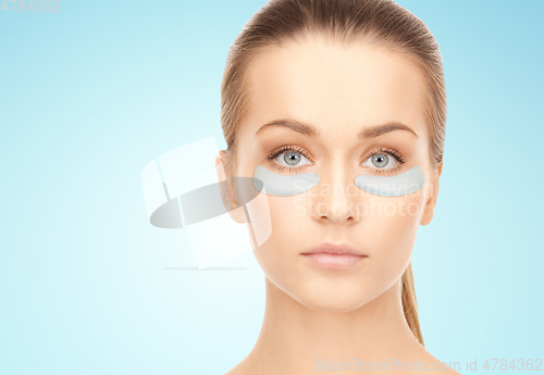 Image of beautiful young woman face with under-eye patches