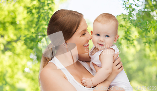 Image of mother with baby over green natural background