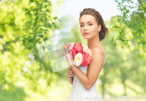 Image of young woman or bride with bouquet of flowers