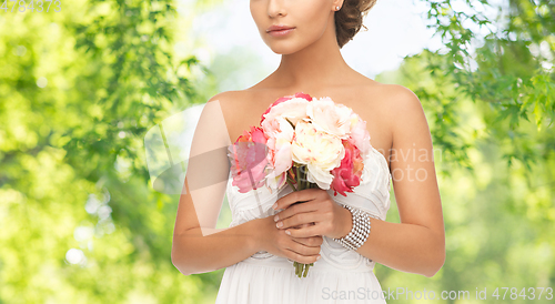 Image of young woman or bride with bouquet of flowers